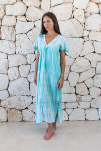 Womens full length tie dye summer dress in aqua blue featuring a hand beaded v neckline, pull ties under the bust, short sleeves and side splits