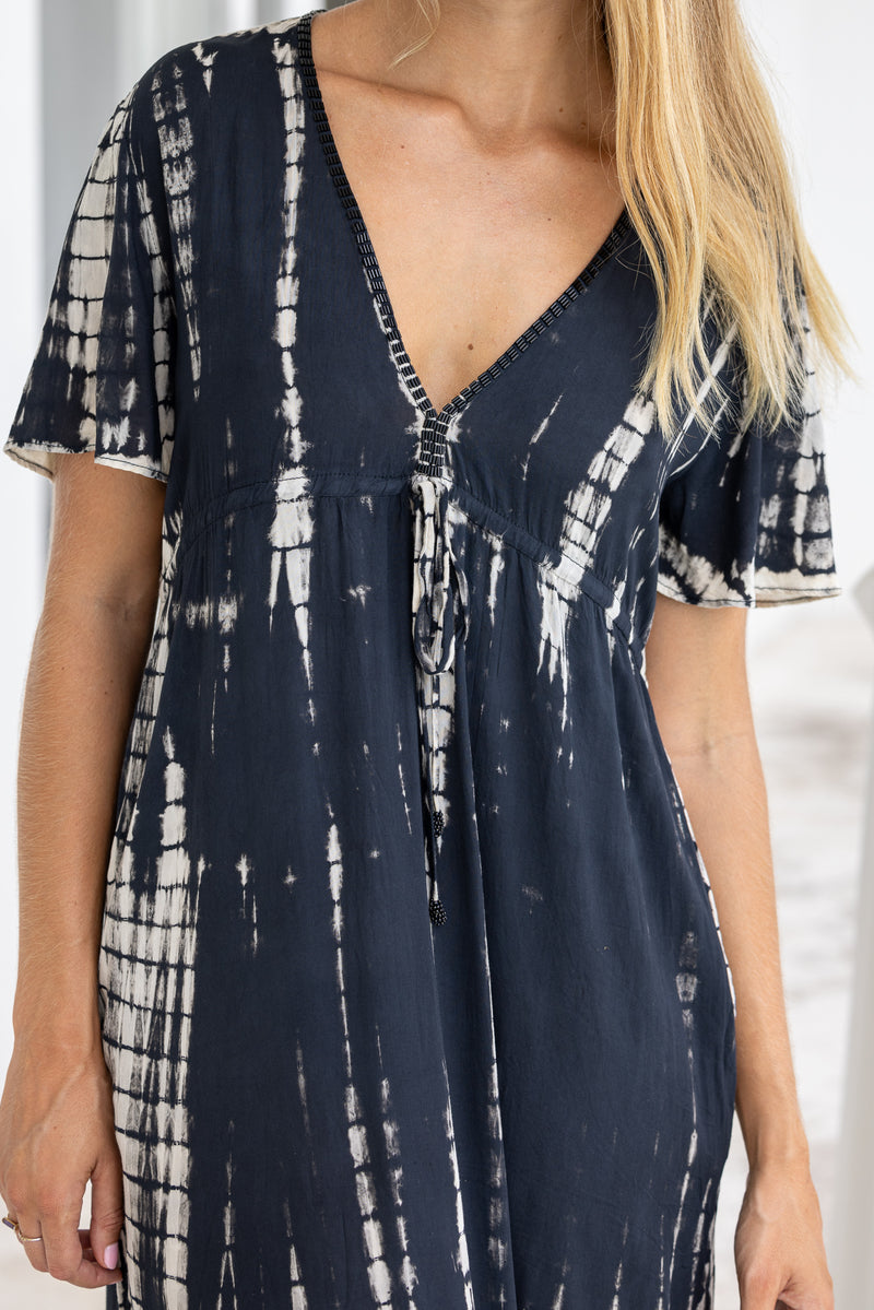 womens full length tie dye summer dress in black featuring a hand beaded v neckline, pull ties under the bust, short sleeves, pockets and side splits