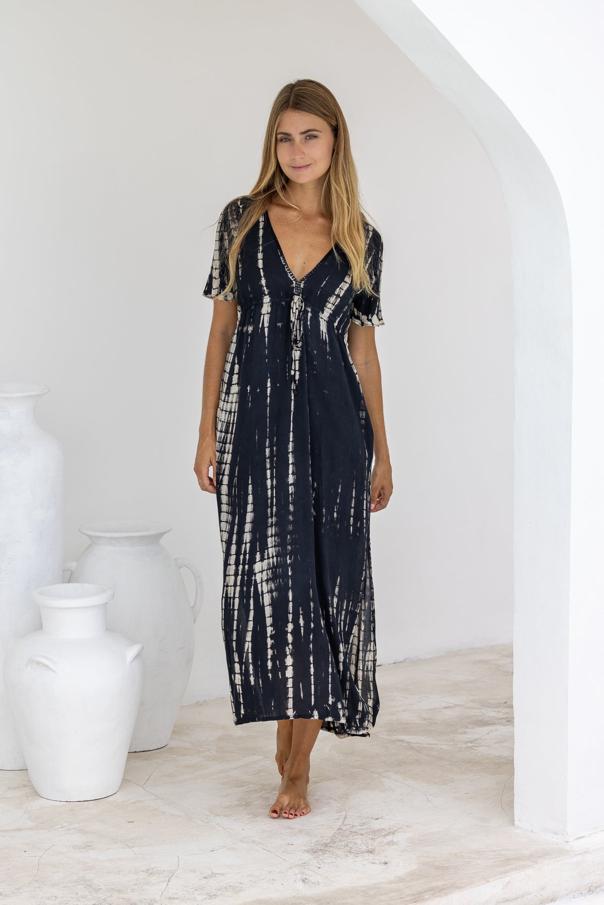 womens full length tie dye summer dress in black featuring a hand beaded v neckline, pull ties under the bust, short sleeves, pockets and side splits