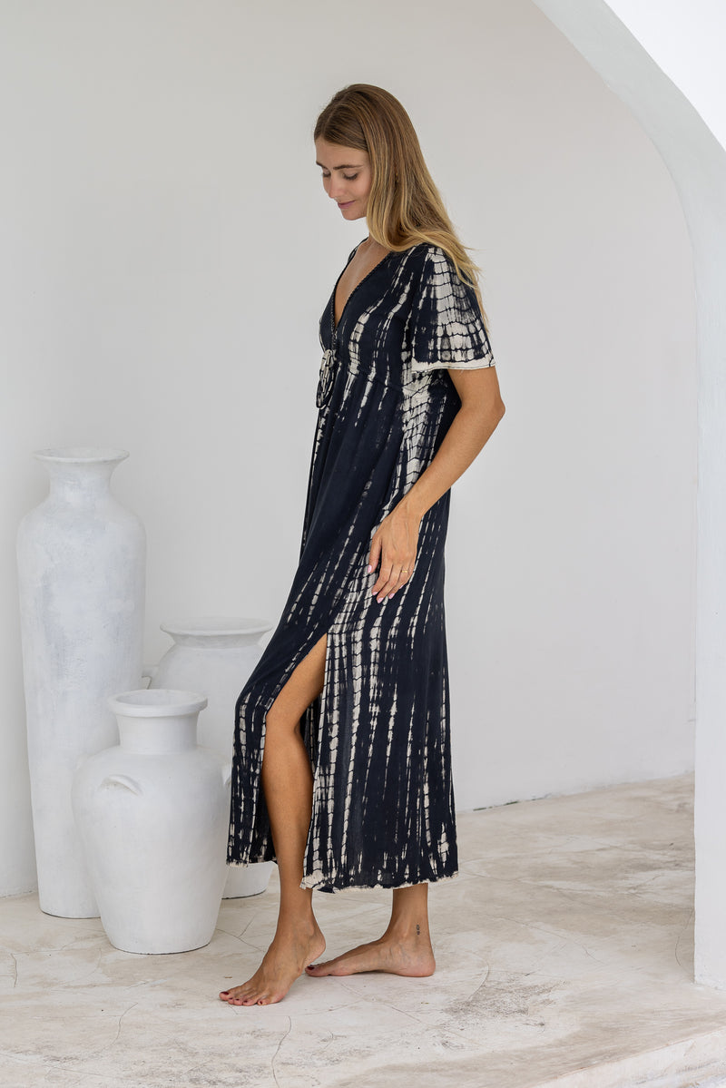 womens full length tie dye summer dress in black featuring a hand beaded v neckline, pull ties under the bust, short sleeves, pockets and side splits