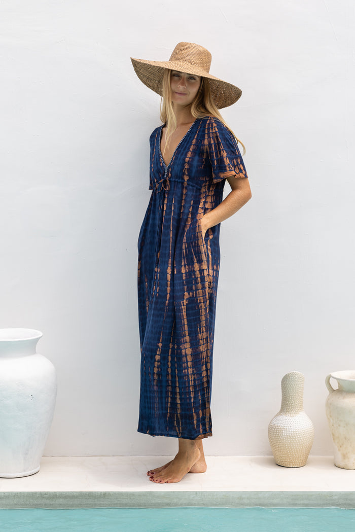 womens full length tie dye summer dress in navy blue and brown  featuring a hand beaded v neckline, pull ties under the bust, short sleeves, pockets and side splits