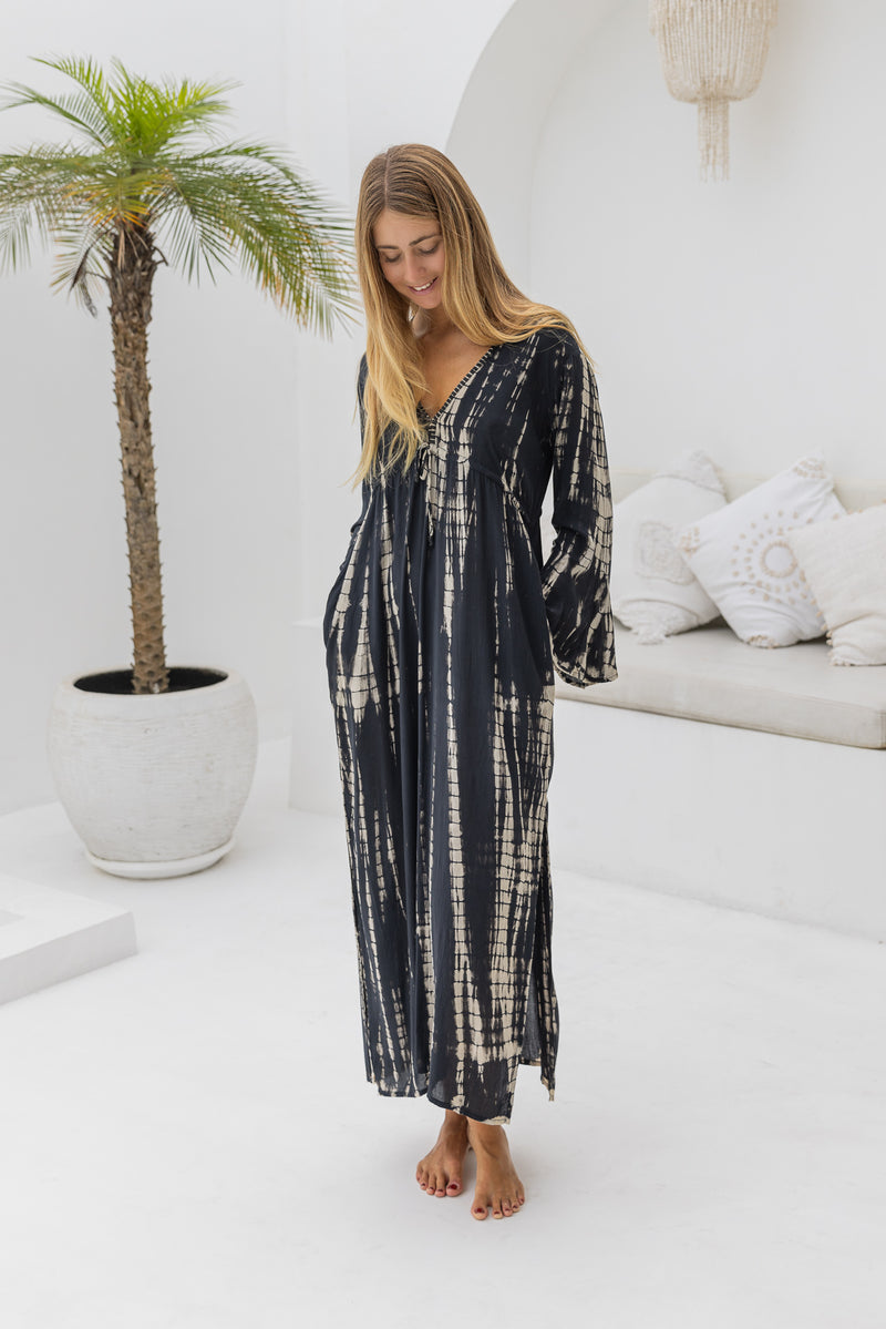 womens full length tie dye summer dress in black featuring a hand beaded v neckline, pull ties under the bust, trumpet sleeves, pockets and side splits
