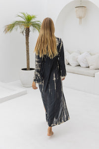 womens full length tie dye summer dress in black featuring a hand beaded v neckline, pull ties under the bust, trumpet sleeves, pockets and side splits
