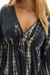 womens full length tie dye summer dress in black featuring a hand beaded v neckline, pull ties under the bust, trumpet sleeves, pockets and side splits