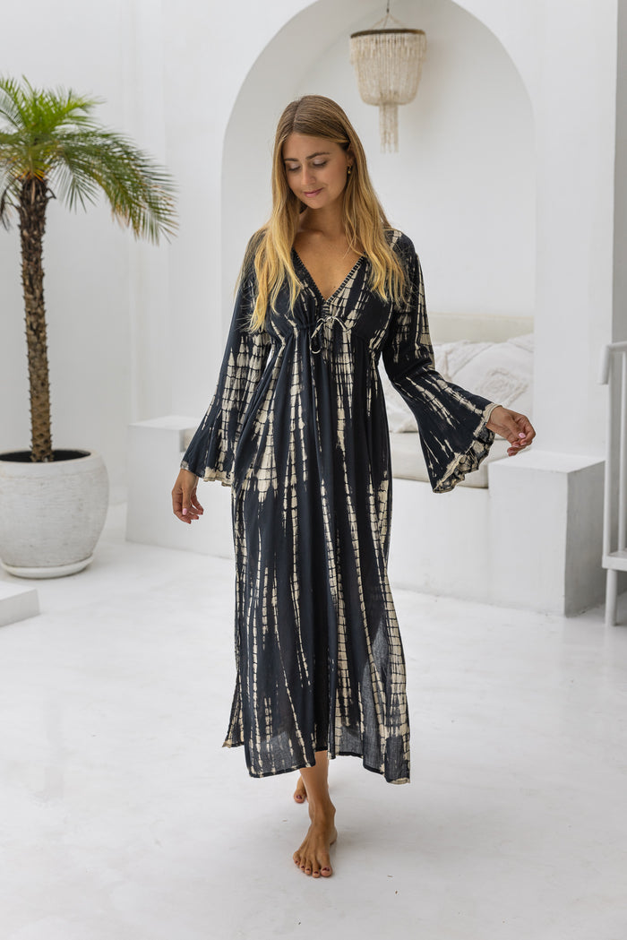 womens full length tie dye summer dress in black featuring a hand beaded v neckline, pull ties under the bust, trumpet sleeves, pockets and side splits