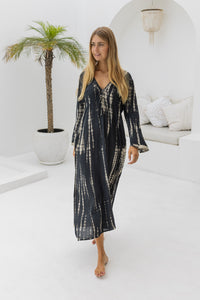 womens full length tie dye summer dress in black featuring a hand beaded v neckline, pull ties under the bust, trumpet sleeves, pockets and side splits