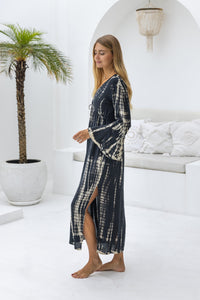 womens full length tie dye summer dress in black featuring a hand beaded v neckline, pull ties under the bust, trumpet sleeves, pockets and side splits