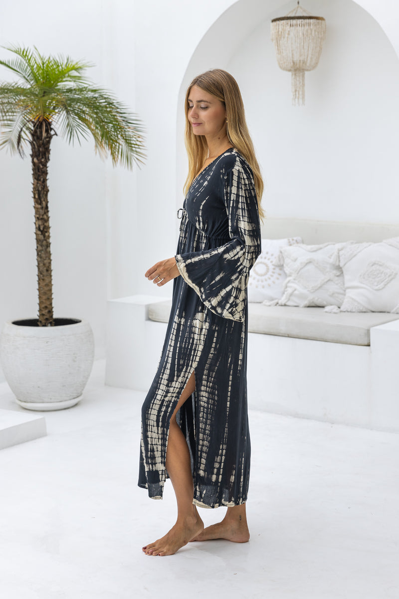 womens full length tie dye summer dress in black featuring a hand beaded v neckline, pull ties under the bust, trumpet sleeves, pockets and side splits