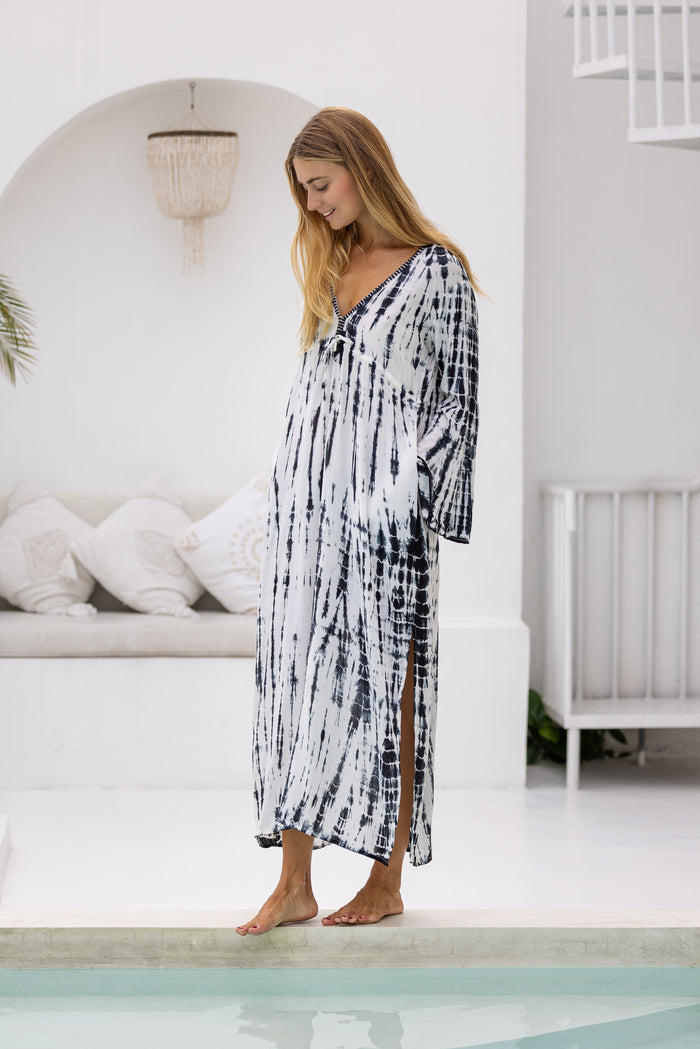 womens full length tie dye summer dress in black featuring a hand beaded v neckline, pull ties under the bust, trumpet sleeves, pockets and side splits