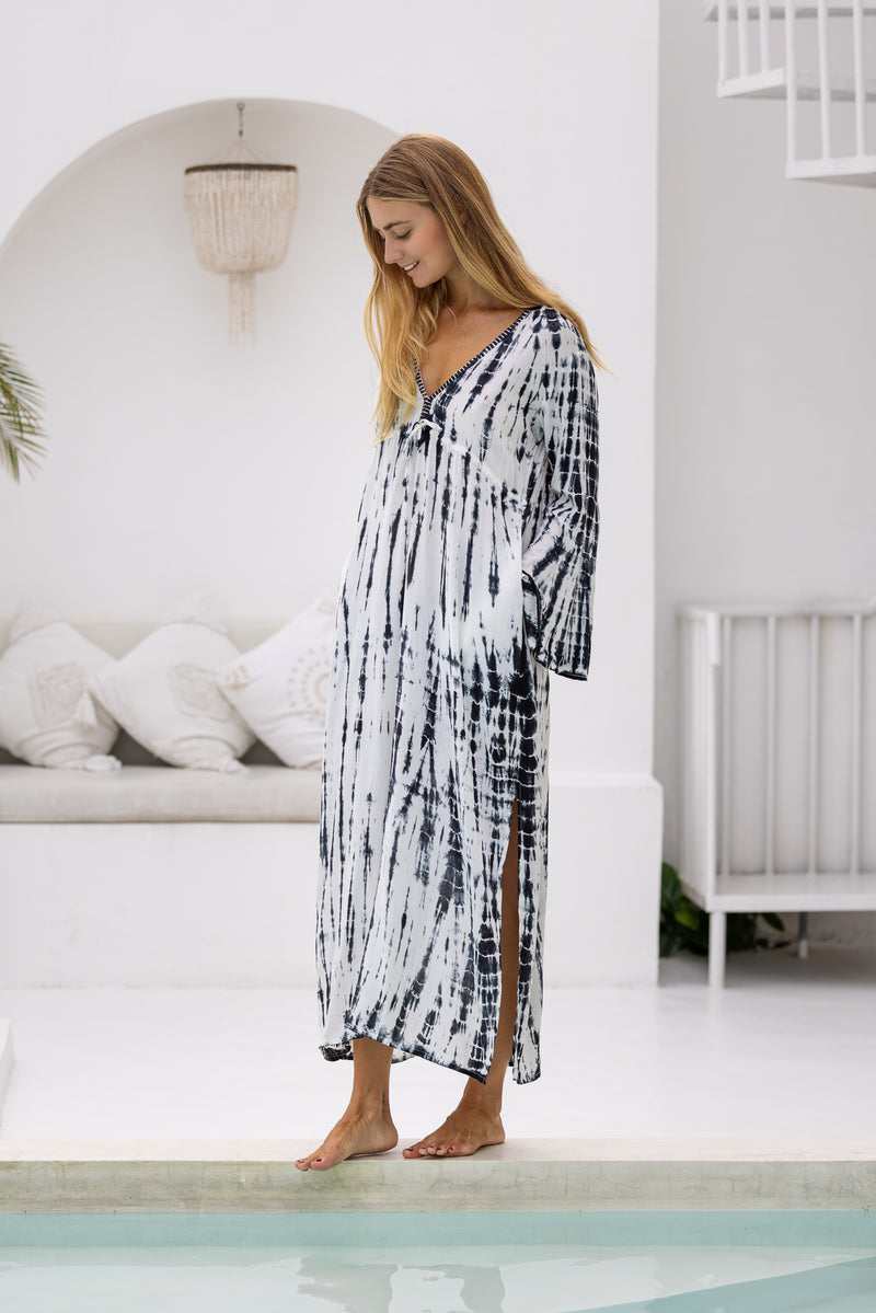 womens full length tie dye summer dress in black featuring a hand beaded v neckline, pull ties under the bust, trumpet sleeves, pockets and side splits