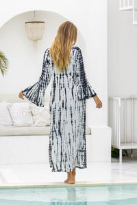 womens full length tie dye summer dress in black featuring a hand beaded v neckline, pull ties under the bust, trumpet sleeves, pockets and side splits