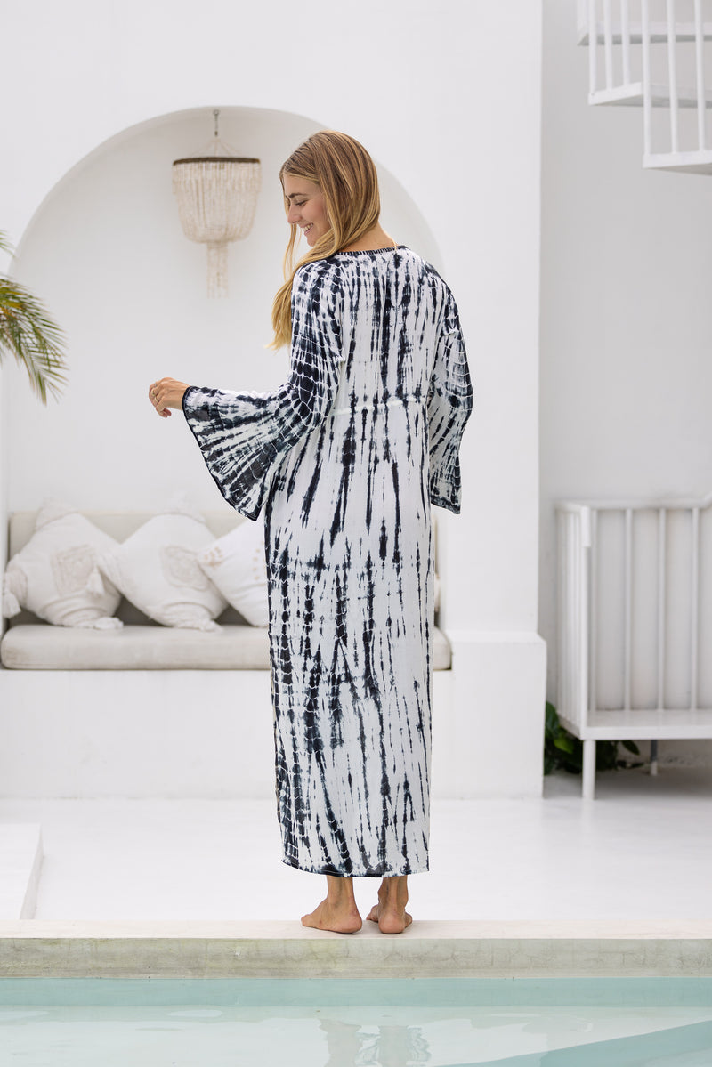 womens full length tie dye summer dress in black featuring a hand beaded v neckline, pull ties under the bust, trumpet sleeves, pockets and side splits