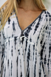 womens full length tie dye summer dress in black featuring a hand beaded v neckline, pull ties under the bust, trumpet sleeves, pockets and side splits