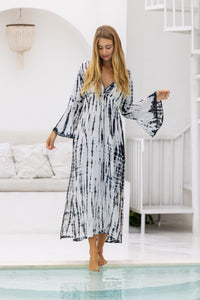 womens full length tie dye summer dress in black featuring a hand beaded v neckline, pull ties under the bust, trumpet sleeves, pockets and side splits