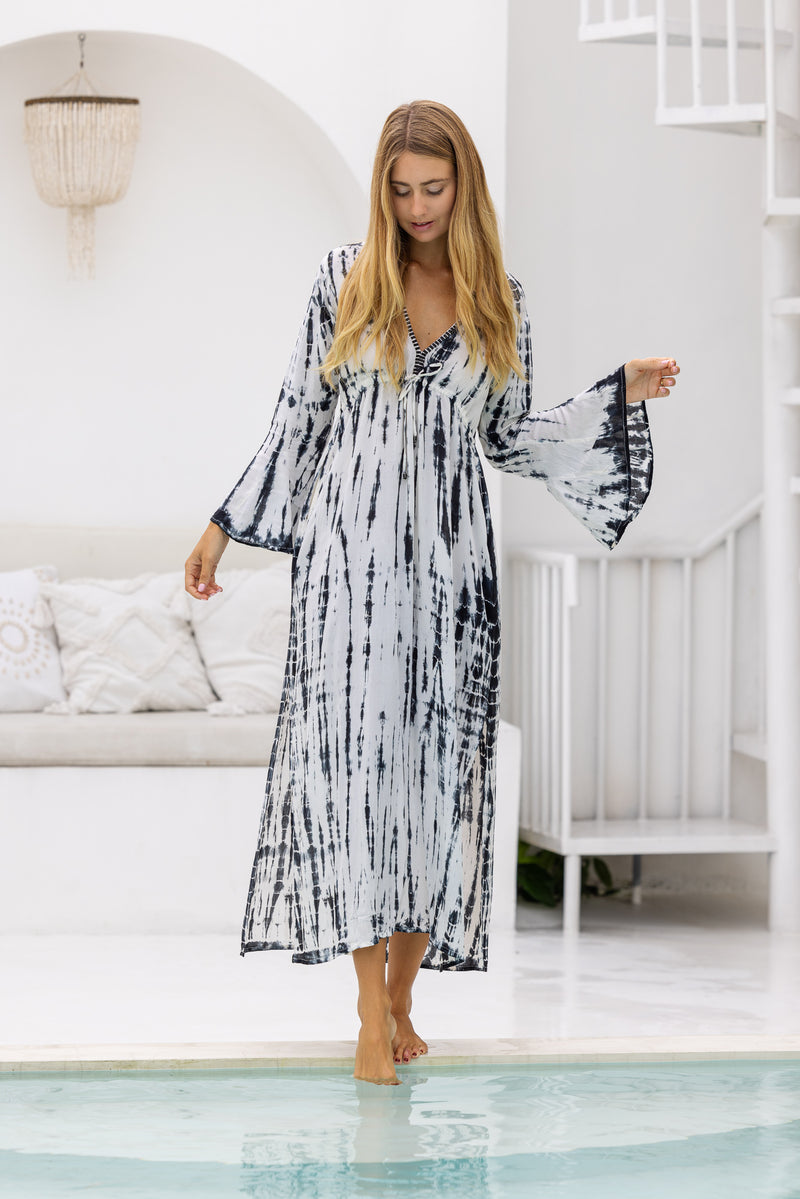 womens full length tie dye summer dress in black featuring a hand beaded v neckline, pull ties under the bust, trumpet sleeves, pockets and side splits