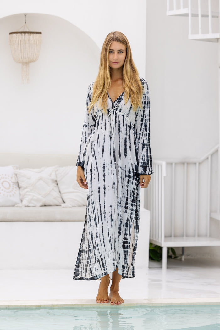 womens full length tie dye summer dress in cream featuring a hand beaded v neckline, pull ties under the bust, trumpet sleeves, pockets and side splits