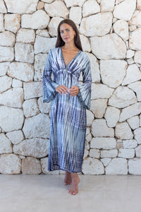 Womens full length tie dye summer dress in dark grey featuring a hand beaded v neckline, pull ties under the bust, trumpet sleeves and side splits