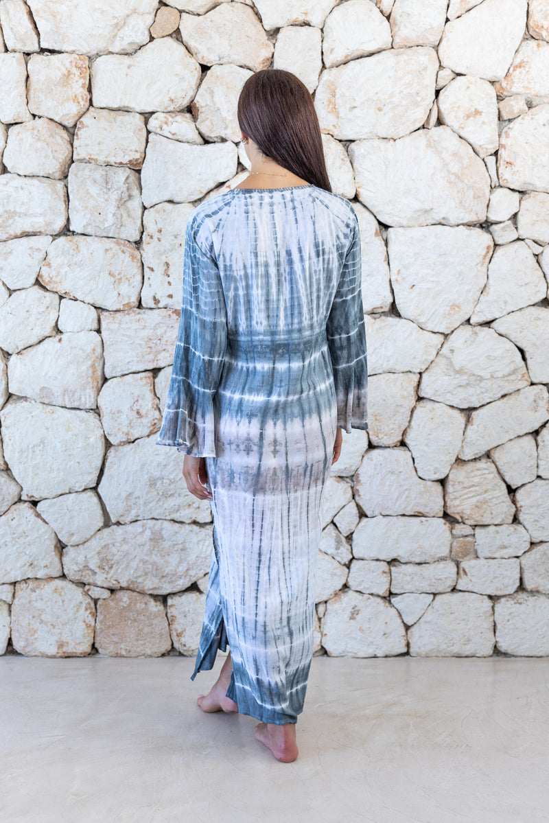 Womens full length tie dye summer dress in light grey featuring a hand beaded v neckline, pull ties under the bust, trumpet sleeves and side splits
