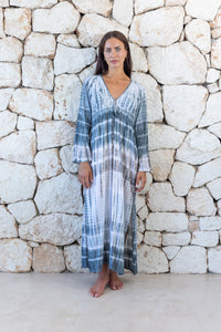 Womens full length tie dye summer dress in light grey featuring a hand beaded v neckline, pull ties under the bust, trumpet sleeves and side splits