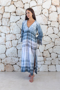 Womens full length tie dye summer dress in light grey featuring a hand beaded v neckline, pull ties under the bust, trumpet sleeves and side splits
