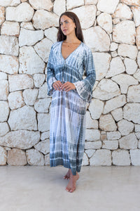 Womens full length tie dye summer dress in light grey featuring a hand beaded v neckline, pull ties under the bust, trumpet sleeves and side splits