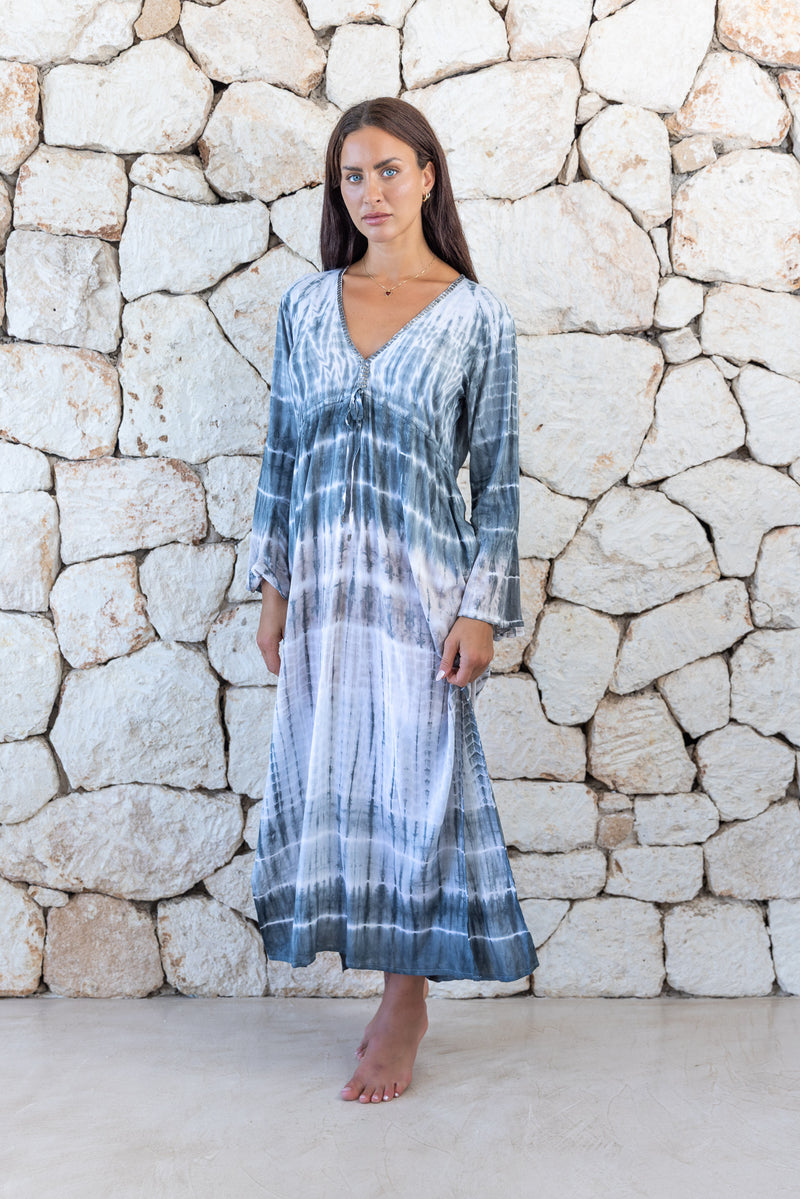 Womens full length tie dye summer dress in light grey featuring a hand beaded v neckline, pull ties under the bust, trumpet sleeves and side splits