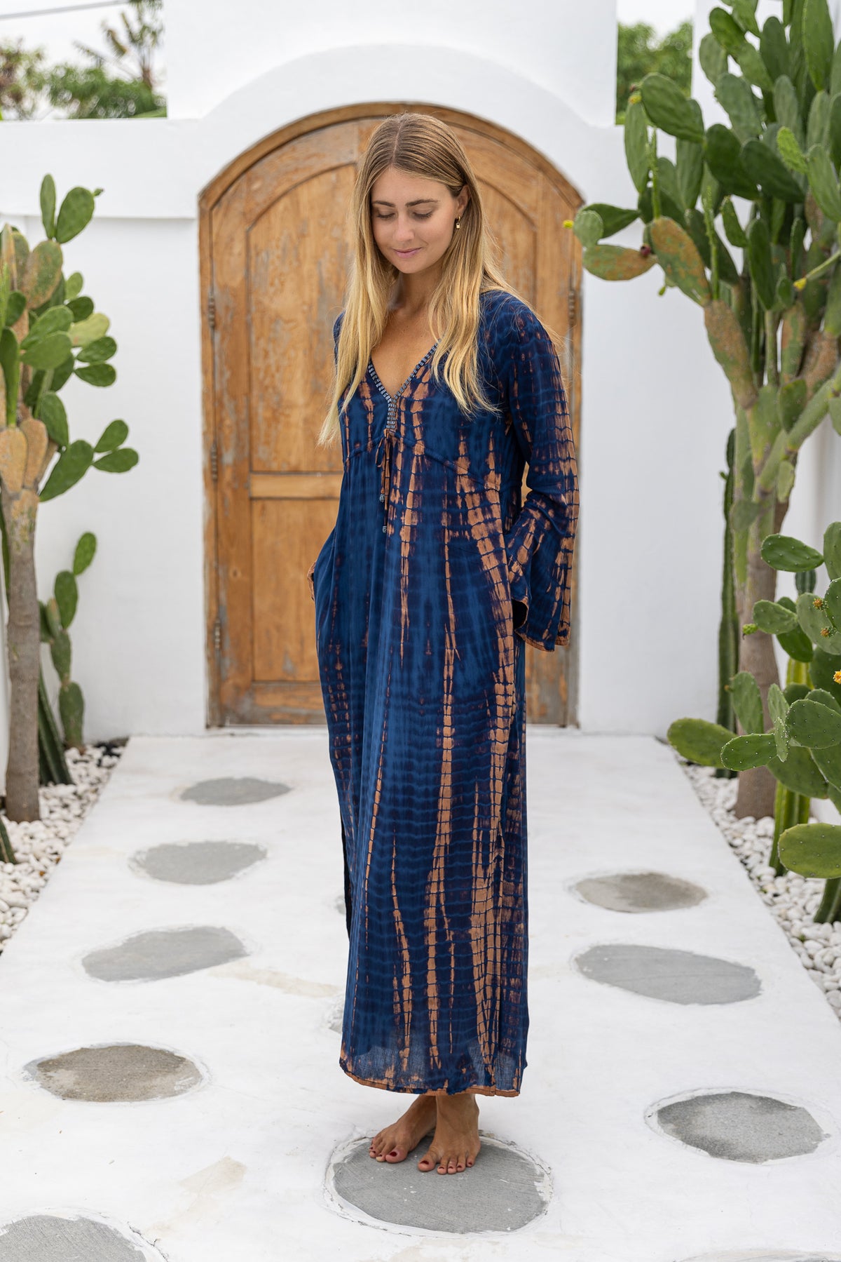 womens full length tie dye summer dress in black featuring a hand beaded v neckline, pull ties under the bust, trumpet sleeves, pockets and side splits