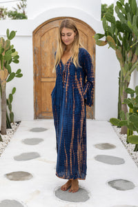 womens full length tie dye summer dress in black featuring a hand beaded v neckline, pull ties under the bust, trumpet sleeves, pockets and side splits
