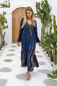 womens full length tie dye summer dress in black featuring a hand beaded v neckline, pull ties under the bust, trumpet sleeves, pockets and side splits
