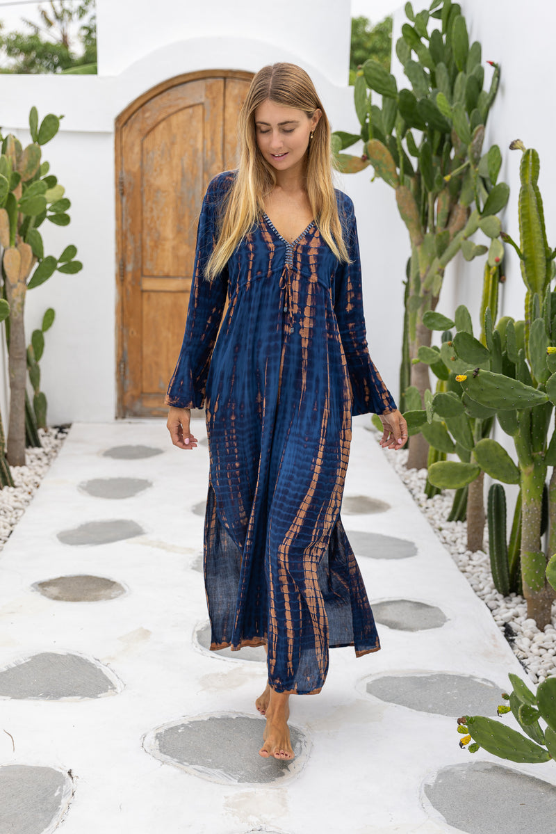 womens full length tie dye summer dress in black featuring a hand beaded v neckline, pull ties under the bust, trumpet sleeves, pockets and side splits
