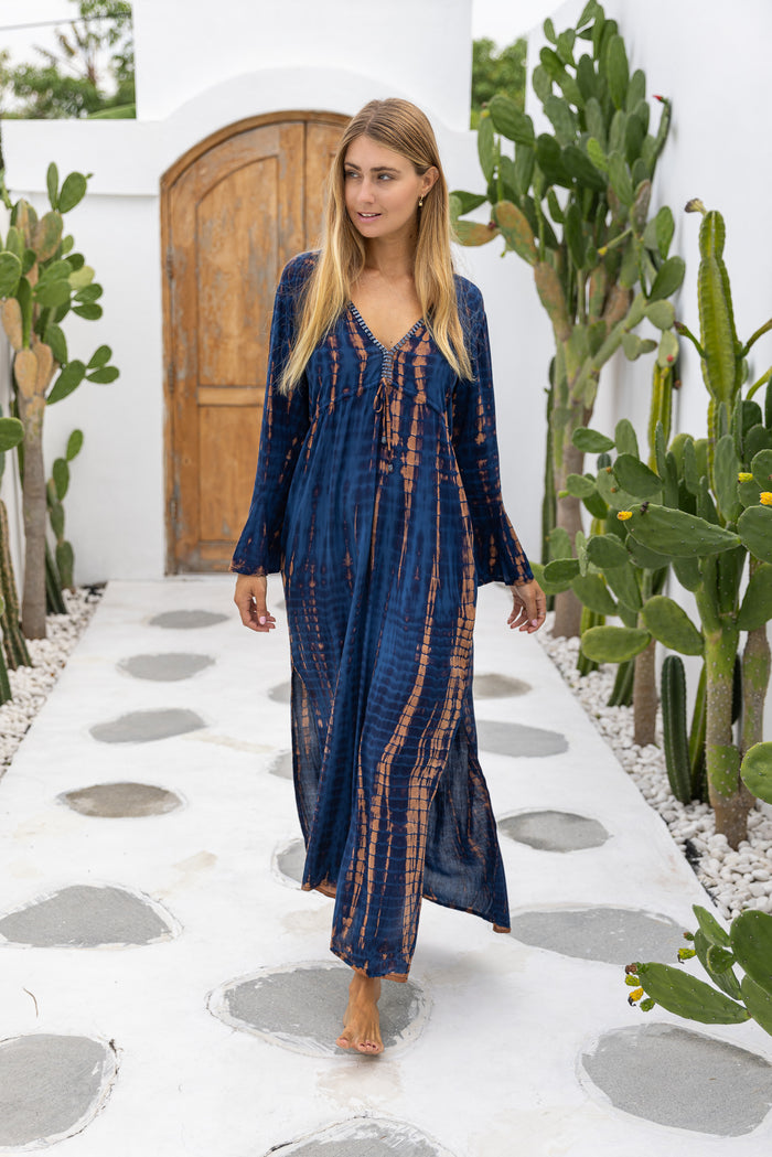 womens full length tie dye summer dress in black featuring a hand beaded v neckline, pull ties under the bust, trumpet sleeves, pockets and side splits