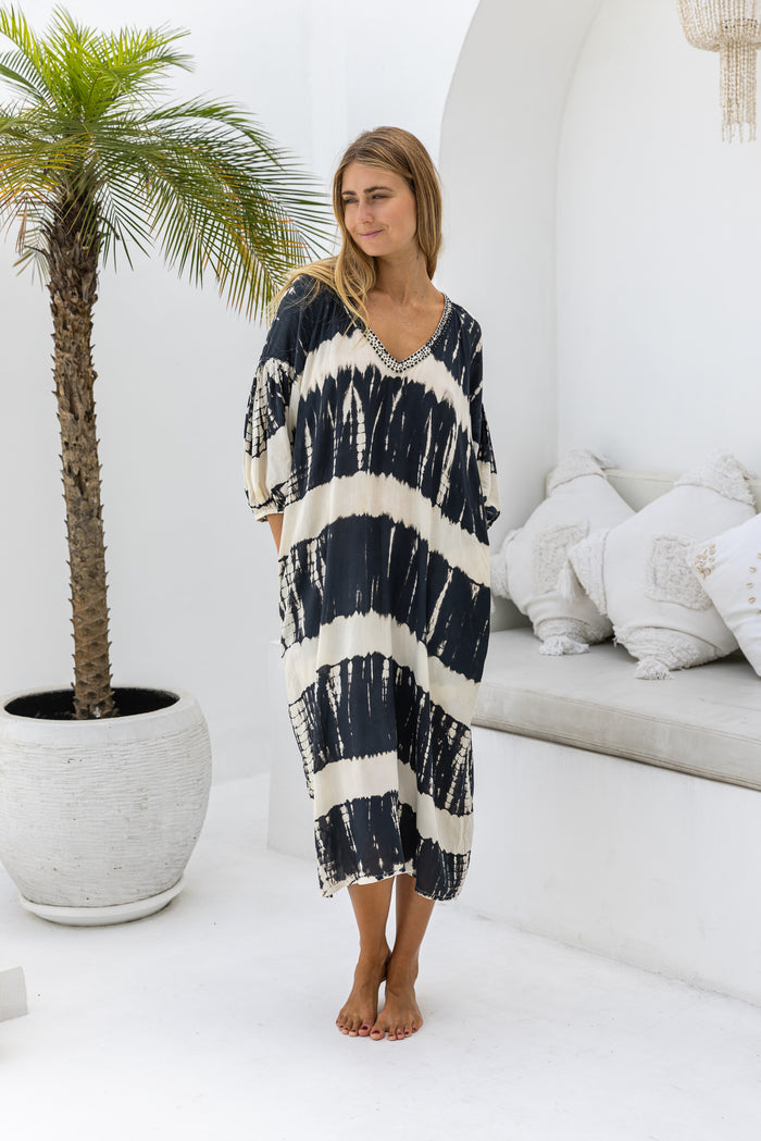 womens mid length oversize tie dye dress in black and cream featuring a hand beaded v neckline, 3/4 length sleeves and pockets