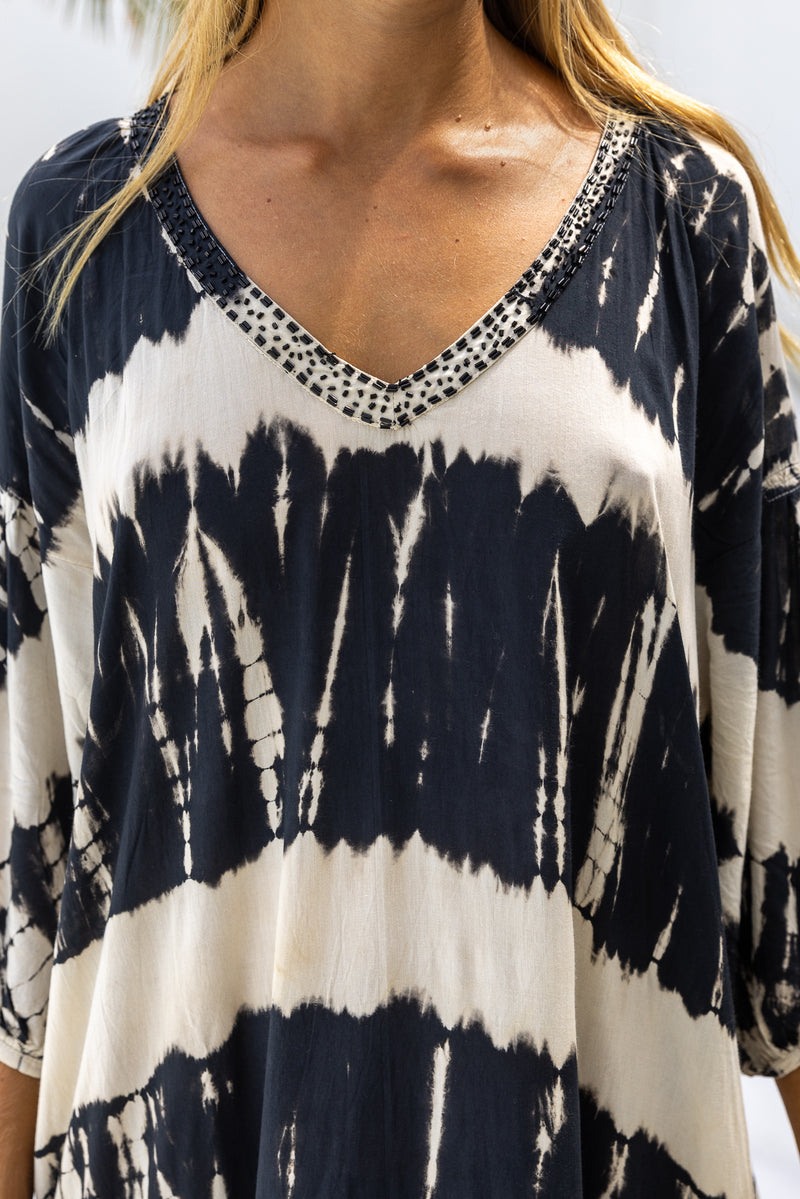 womens mid length oversize tie dye dress in black and cream featuring a hand beaded v neckline, 3/4 length sleeves and pockets