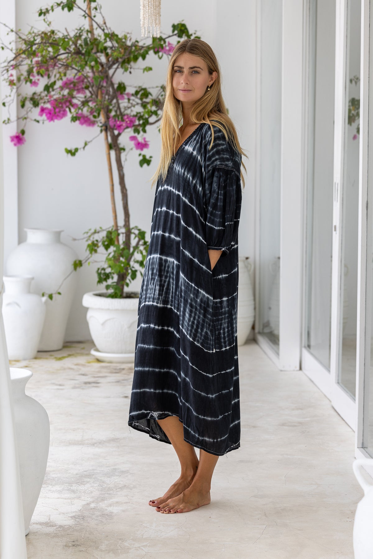 womens mid length oversize tie dye dress in black and cream featuring a hand beaded v neckline, 3/4 length sleeves and pockets