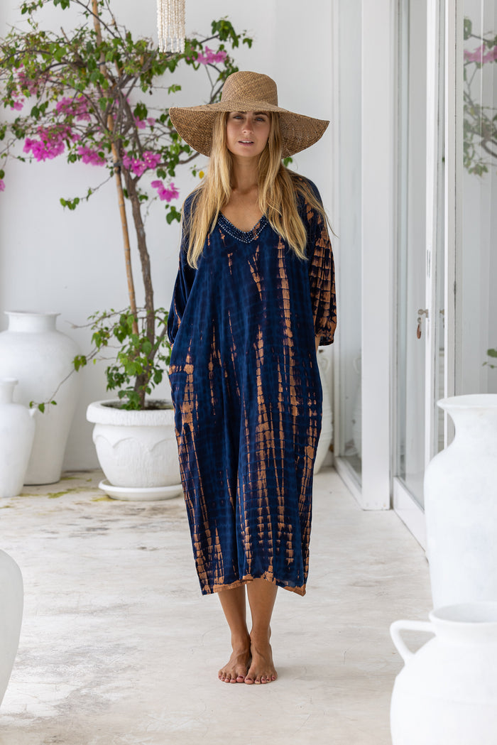 womens mid length oversize tie dye dress in navy blue and brown featuring a hand beaded v neckline, 3/4 length sleeves and pockets