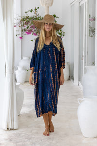 womens mid length oversize tie dye dress in navy blue and brown featuring a hand beaded v neckline, 3/4 length sleeves and pockets