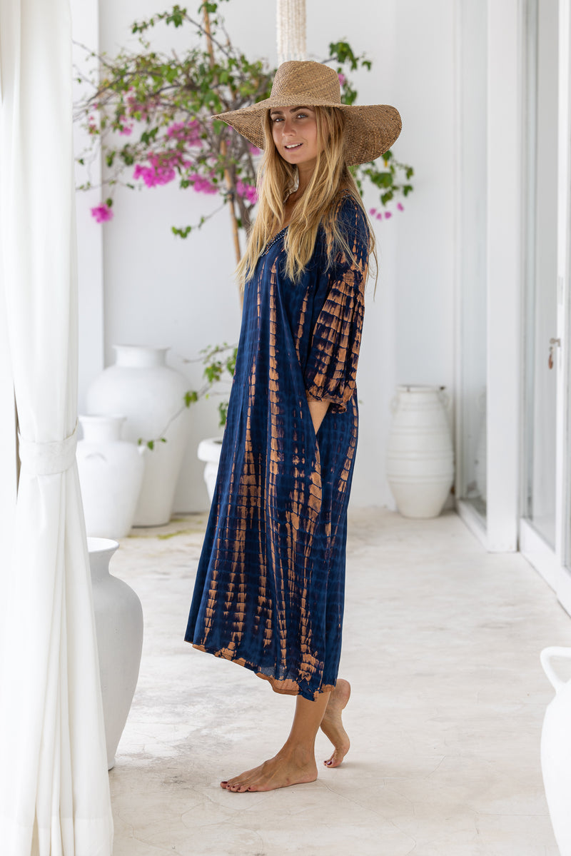 womens mid length oversize tie dye dress in navy blue and brown featuring a hand beaded v neckline, 3/4 length sleeves and pockets