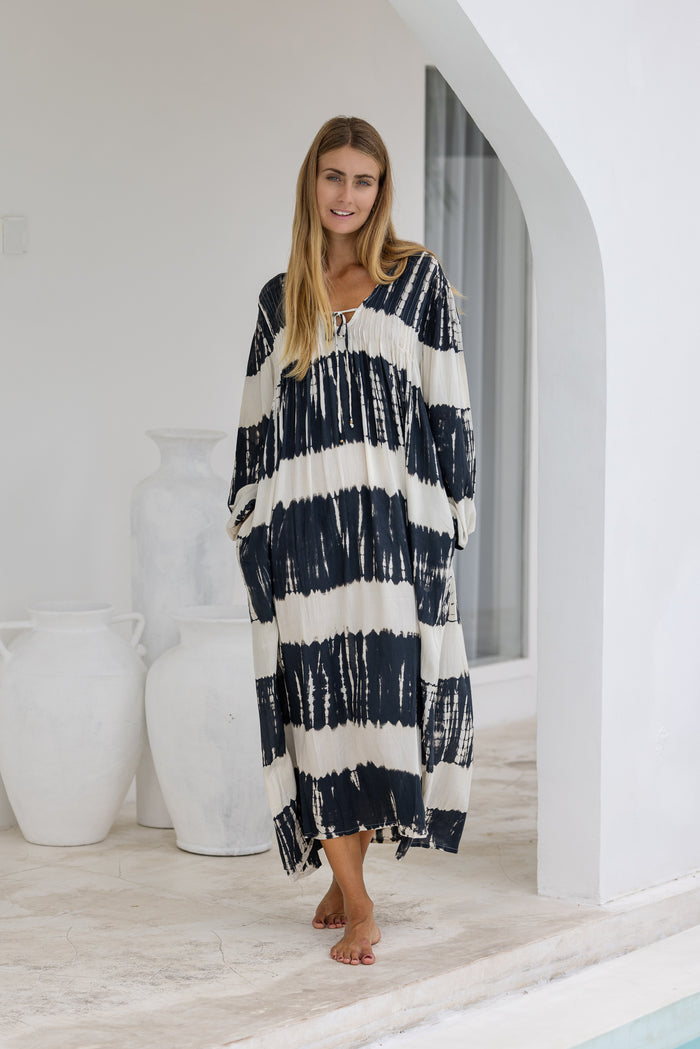 tie dye oversize dress in black and cream featuring tie detail, side pockets and long sleeves