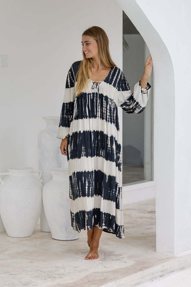 tie dye oversize dress in black and cream featuring tie detail, side pockets and long sleeves