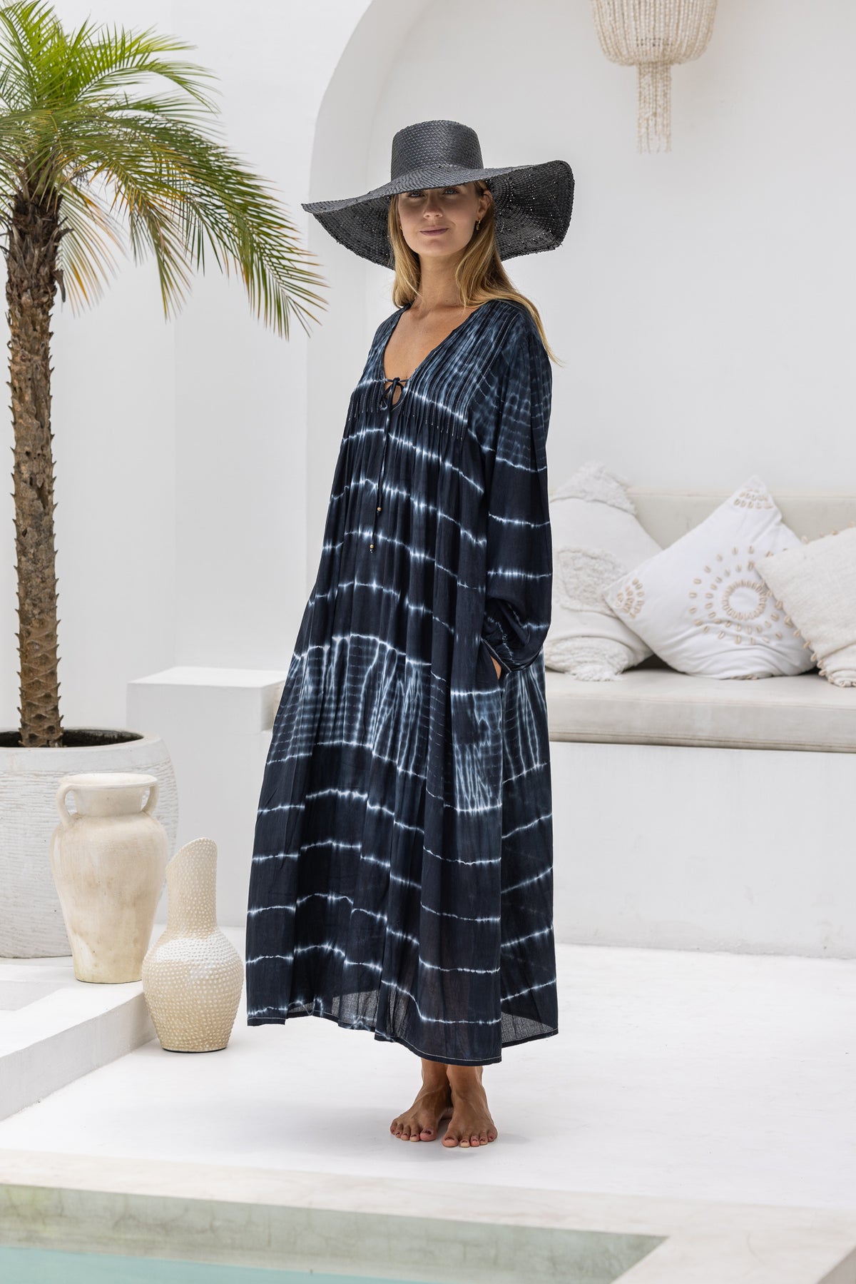 tie dye oversize dress in black and cream featuring tie detail, side pockets and long sleeves