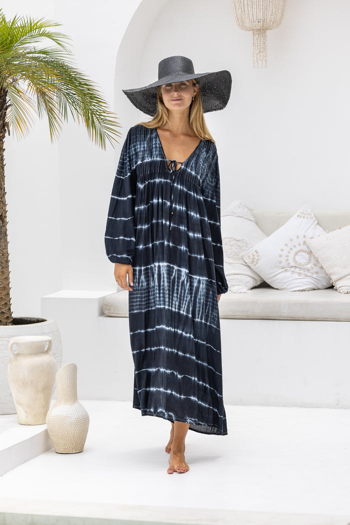 tie dye oversize dress in black and cream featuring tie detail, side pockets and long sleeves