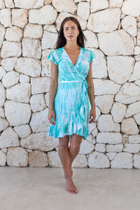 Womens super soft, lightweight, short length wrap tie dye dress in aqua blue featuring a ruffle detail and a self tie fastening