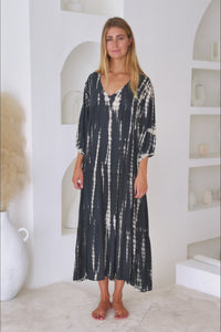 womens mid length tie dye tiered tunic dress in black featuring a v neckline, long sleeves and side pockets