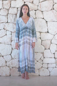 Womens full length tie dye summer dress in light grey featuring a hand beaded v neckline, pull ties under the bust, trumpet sleeves and side splits