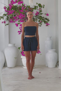 Womens super soft, 100% cotton relaxed Boxer Shorts in navy blue featuring an elasticated waist, with a pull tie decoration and side pockets