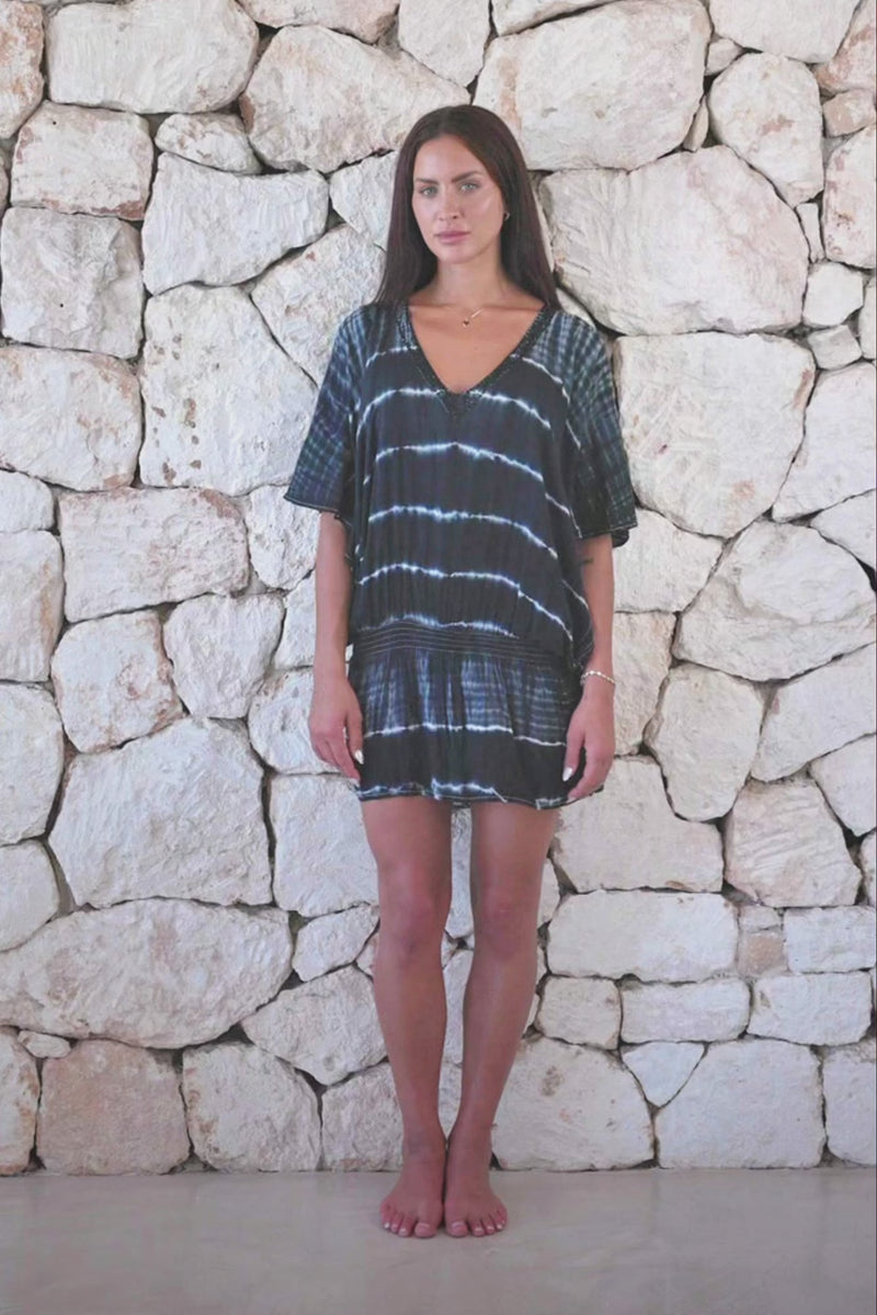 Womens stylish, super soft, lightweight, short length kaftan tie dye dress in black and cream featuring an elasticated waist and hand beaded v neckline