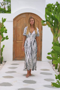 womens full length tie dye summer dress in black featuring a hand beaded v neckline, pull ties under the bust, short sleeves, pockets and side splits