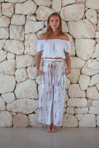 Stylish, super soft wide leg culotte style tie-dye trousers in white and copper featuring an elasticated waist, belt detail and pockets for a flattering and comfortable fit