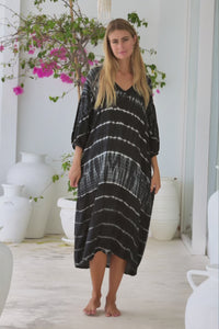 womens mid length oversize tie dye dress in black and cream featuring a hand beaded v neckline, 3/4 length sleeves and pockets