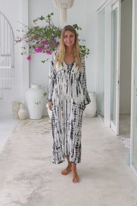 womens full length tie dye summer dress in black featuring a hand beaded v neckline, pull ties under the bust, trumpet sleeves, pockets and side splits